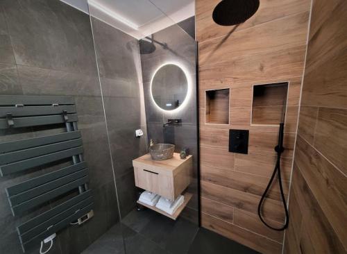 a bathroom with a shower with a sink and a mirror at Magnifique Studio 2 personnes - VUE MER "La Perle de Jade" in Saint-Michel-Chef-Chef