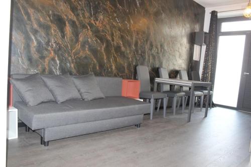 a living room with a couch and a table at Monolocale in Verona