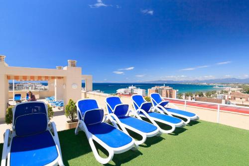 a row of blue and white chairs on a balcony at UHC Central Park Apartments in Salou