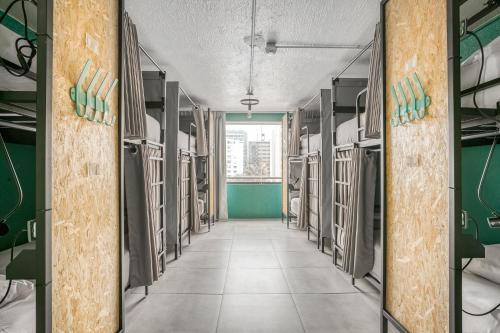 a hallway of a prison cell with a long corridor at Selina Miraflores Lima in Lima