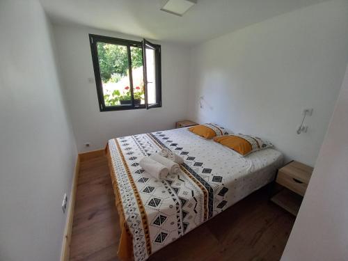 a bedroom with a bed and a window at Appartement en rez de jardin in Thénésol