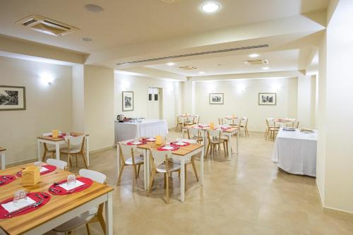 a dining room with tables and chairs in a room at Verdello Home Savoca in Savoca 