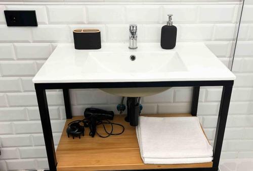 a sink in a bathroom with a white counter at Casa Encina in Murcia