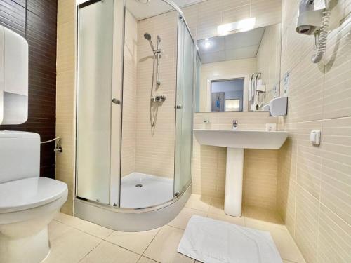 a bathroom with a shower and a toilet and a sink at PracticOtel in Kyiv