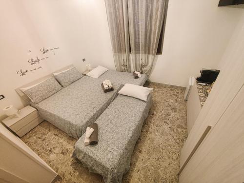 a bedroom with two beds with shoes on them at Villa Turicchio in Taranto