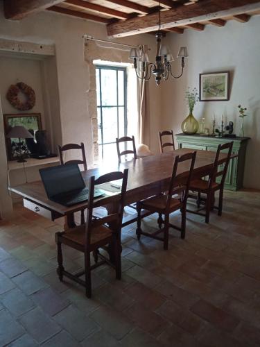a dining room with a large wooden table and chairs at Mazet Des Artistes in Mouriès