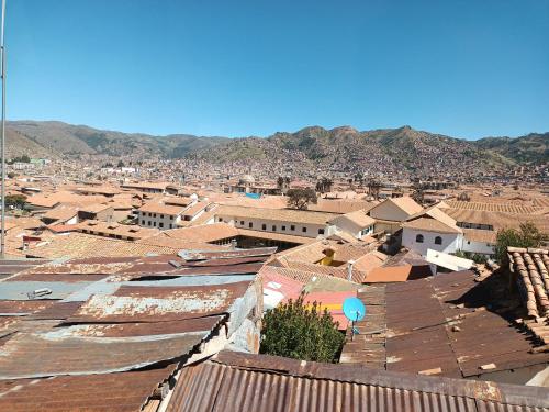 a view of a city with roofs and buildings at Paqarina San Blas in Cusco