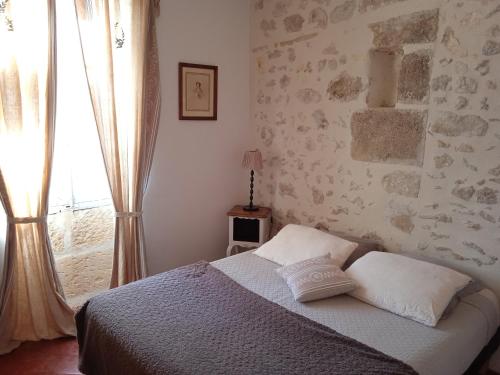 a bedroom with a bed and a window at Mazet Des Artistes in Mouriès