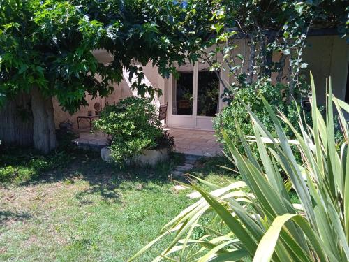 a front door of a house with a bench at Mazet Des Artistes in Mouriès