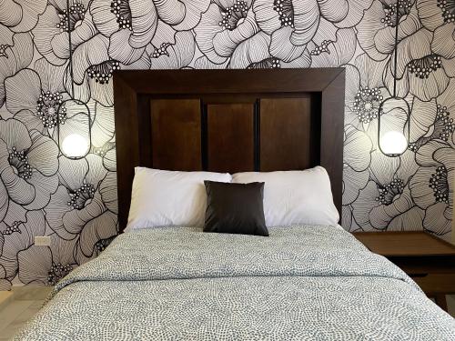 a bedroom with a bed with a black and white wallpaper at Ancla Suite 8 - 2 Bedroom Urban Hotel in Puerto Peñasco