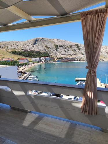 a view of a harbor from a room with a window at Apartments Katica in Metajna