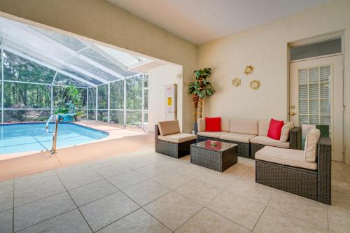 a living room with a pool in the background at 4 Mi to Rainbow Springs Dunnellon Villa with Pool! in Dunnellon
