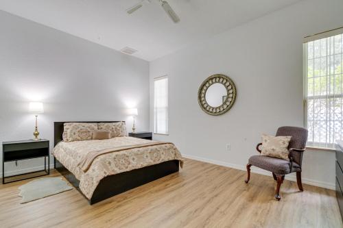 a bedroom with a bed and a chair and a mirror at 4 Mi to Rainbow Springs Dunnellon Villa with Pool! in Dunnellon