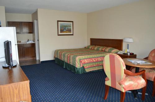 a hotel room with a bed and a desk at Bluegrass Extended Stay in Lexington