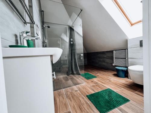 a bathroom with a shower and a sink and a toilet at Zacisze in Karczmiska