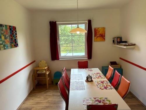 a dining room with a table and chairs and a window at Chalupa Měňany - Karlštejn in Beroun