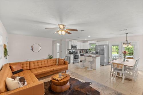a living room with a couch and a table at The Gator Getaway- Huge Backyard in Gainesville