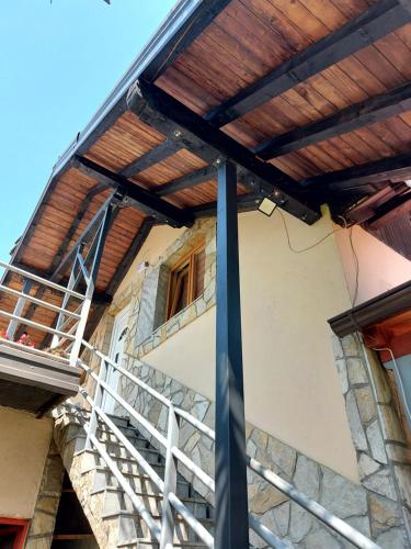a building with a wooden roof and a staircase at Vista Point Apartment in Bajina Bašta
