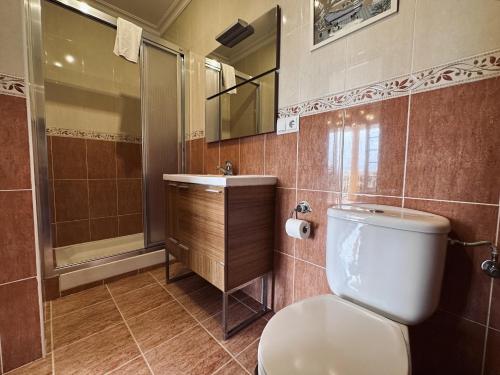a bathroom with a toilet and a sink and a shower at Villa Tarredonas - 12803 in Ajo