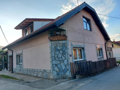 a small house with a stone facade on a street at Vista Point Apartment in Bajina Bašta