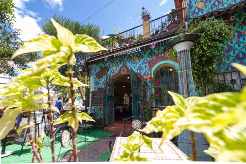 a building with a colorful facade with plants in front of it at ArtPlaza in Quito