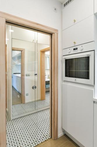 a bathroom with a glass shower and a mirror at Královské apartmá kolonáda in Poděbrady
