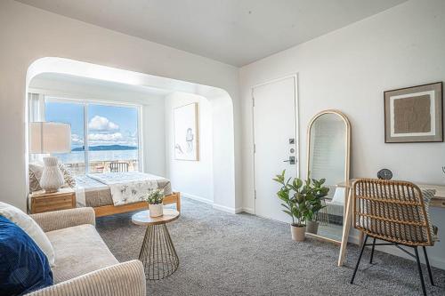 a living room with a bed and a large window at Waterfront Bliss, 2 BR Apt near Alki Beach in Seattle