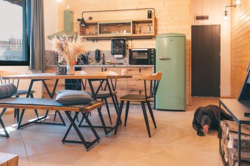 a dog is laying on the floor in a kitchen at Dakota forest retreat in Tsigov Chark