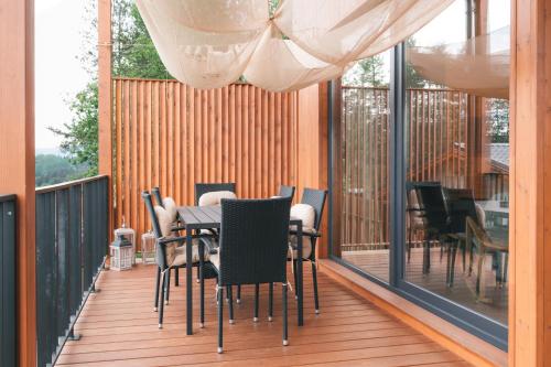 a patio with a table and chairs on a deck at Dakota forest retreat in Tsigov Chark