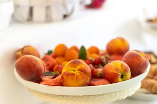 a white bowl of fruit on a table at Hotel La Luna in Ischia