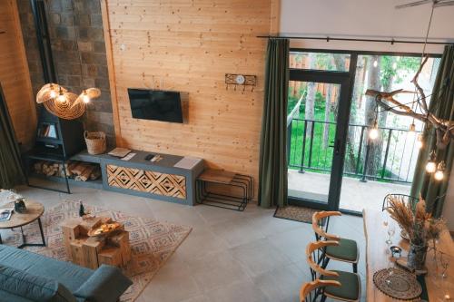 a living room with a couch and a tv at Dakota forest retreat in Tsigov Chark