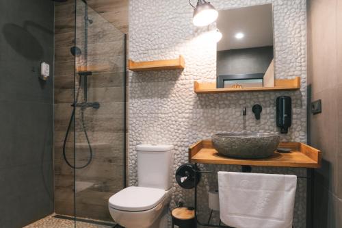 a bathroom with a shower and a toilet and a sink at Dakota forest retreat in Tsigov Chark