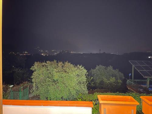 a view of a city at night with an orange bench at Villa Lidia & Attico degli artisti, free pets , giardino recintato e attrezzato in Minturno