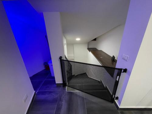 a staircase in a building with a blue background at Villa Lidia & Attico degli artisti, free pets , giardino recintato e attrezzato in Minturno