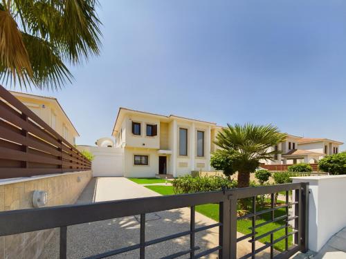 a view of a house with a fence at Amazing frontline beach villa in Larnaca
