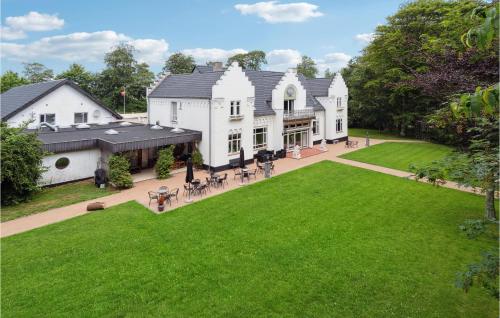 an aerial view of a large white house with a lawn at 11 Bedroom Cozy Home In Gørding in Gørding