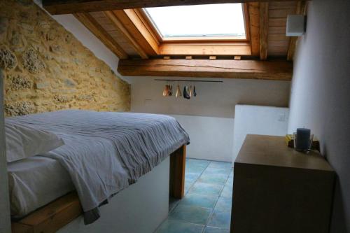 a bedroom with a bed and a window and a table at Monti D'Abruzzo holiday home in Crecchio