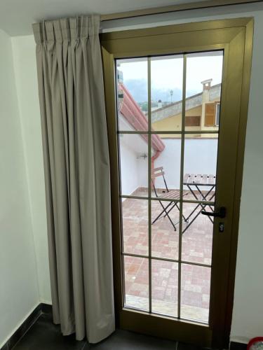 a sliding glass door with a view of a patio at Villa Lidia & Attico degli artisti, free pets , giardino recintato e attrezzato in Minturno