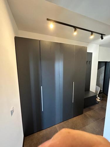 a sliding glass door in a room with a toilet at Modern Apartment Sarajevo in Sarajevo