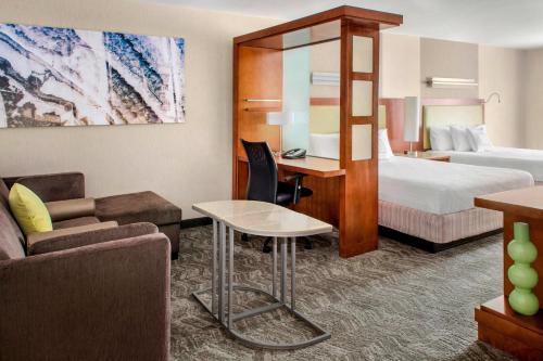 ベルポートにあるSpringHill Suites Long Island Brookhavenのベッドとデスクが備わるホテルルームです。