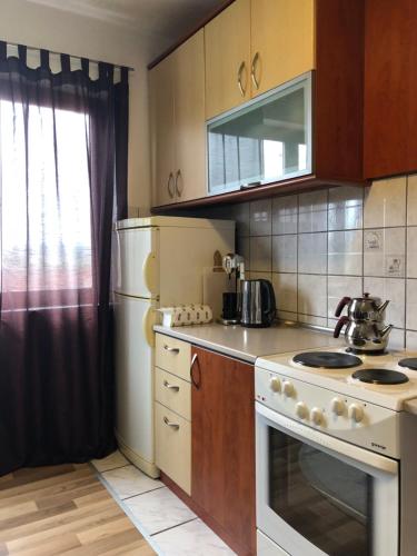 a kitchen with a white stove and a refrigerator at House For Rent in Pristina