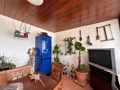 a living room with a blue cabinet and a tv at La Foggia seaside paradise in Siculiana