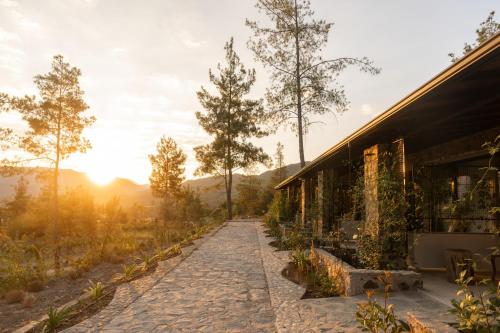 a house with a stone path next to a building at IZZ Getaway - Adults Only in Göcek