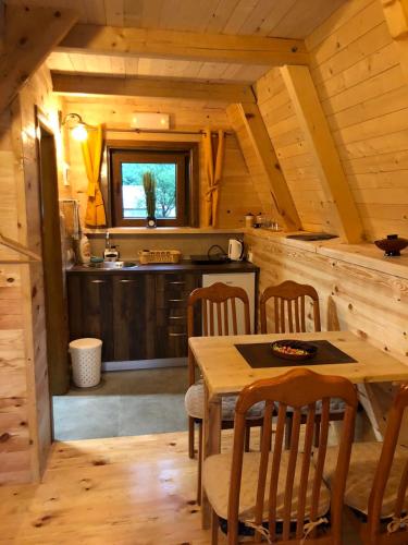 a kitchen with a table and chairs in a cabin at Family S house - Komarnica in Šavnik