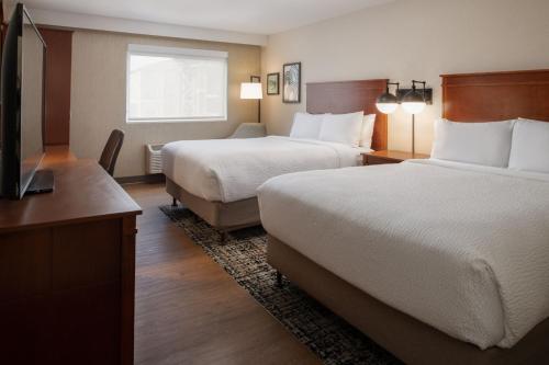 a hotel room with two beds and a flat screen tv at Four Points by Sheraton Bellingham Hotel & Conference Center in Bellingham