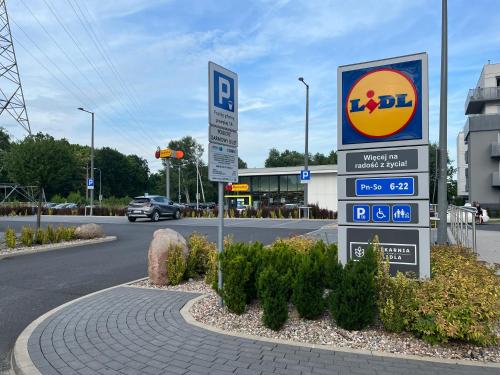 a sign for a gas station on the side of a road at Malta Lake - Apartment in Poznań