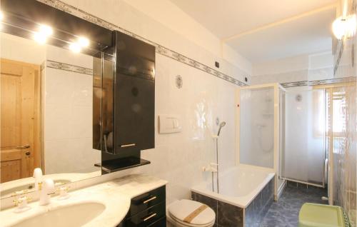 a bathroom with a sink and a toilet and a shower at Amazing Apartment In Mezzana With Wifi in Mezzana