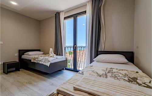 1 Schlafzimmer mit 2 Betten und einem großen Fenster in der Unterkunft Stunning Apartment In Orebic With Kitchen in Orebić