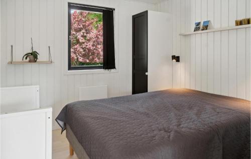 a bedroom with a bed and a window at Gorgeous Home In Stege With Wifi in Stege