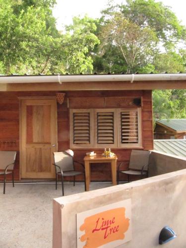 a sign on a patio with a table and chairs at Castara Retreats in Castara
